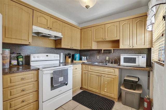 kitchen featuring light brown cabinetry, light tile patterned flooring, and white appliances