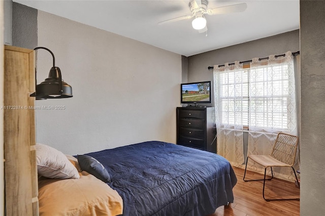 bedroom with hardwood / wood-style floors and ceiling fan