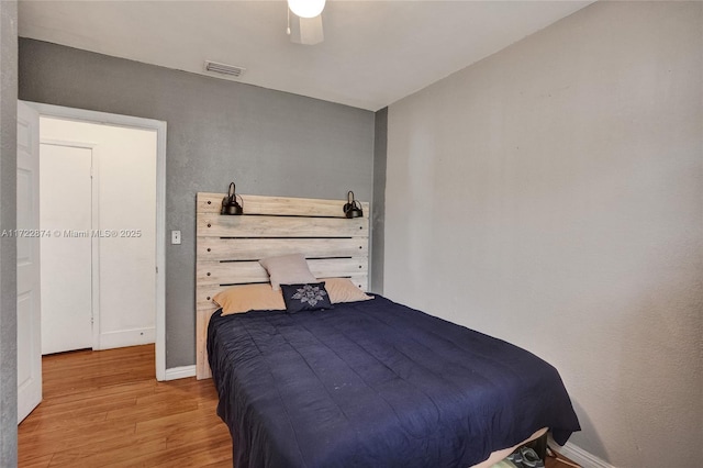 bedroom with light wood-type flooring and ceiling fan