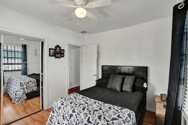 bedroom with a closet, ceiling fan, and hardwood / wood-style floors