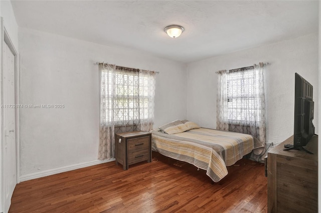 bedroom featuring hardwood / wood-style flooring and multiple windows