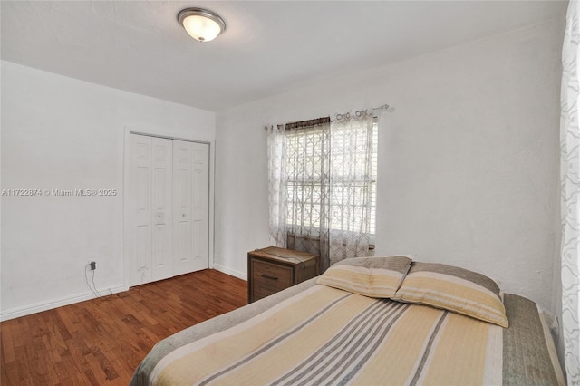 bedroom with wood-type flooring and a closet