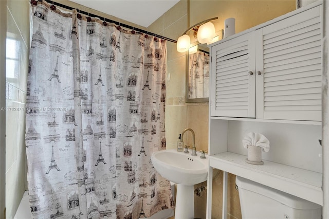 bathroom with a shower with curtain and toilet