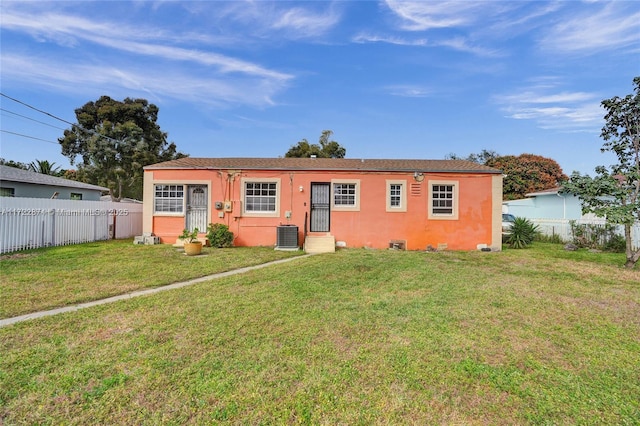 rear view of property with a yard