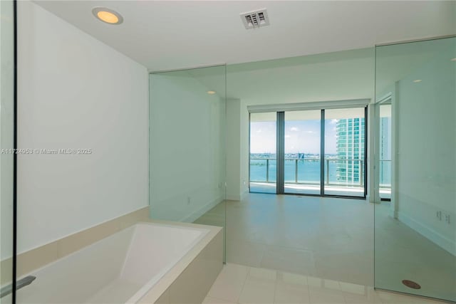 bathroom with a washtub and a water view