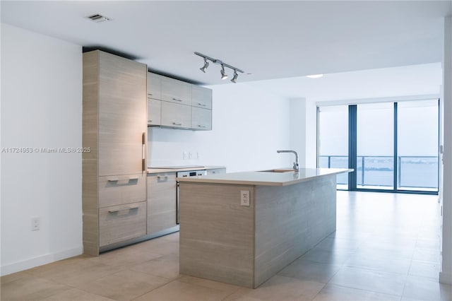 650 NE 32nd St Unit 2703, Miami, FL 33137 - kitchen with modern cabinets, track lighting, an island with sink, light countertops, and light tile patterned floors