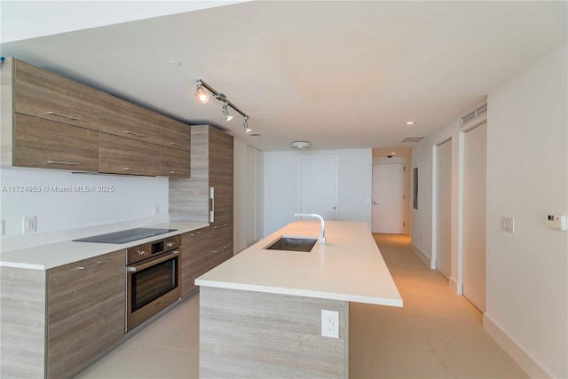 650 NE 32nd St Unit 2703, Miami, FL 33137 - kitchen with oven, modern cabinets, black electric stovetop, and light countertops
