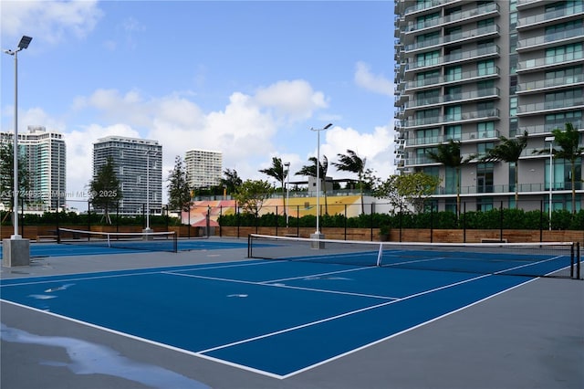 view of sport court with basketball hoop