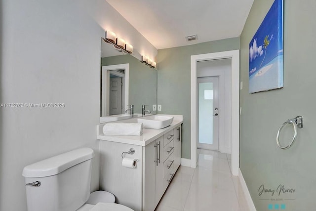 bathroom featuring tile patterned flooring, vanity, and toilet