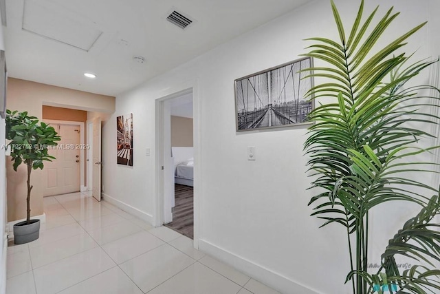 corridor featuring light tile patterned floors