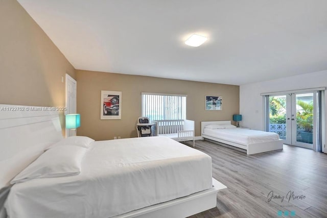 bedroom with wood-type flooring, access to outside, and french doors