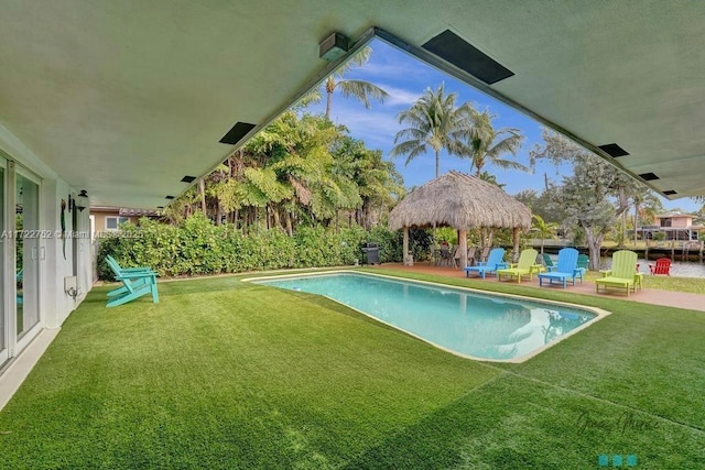 view of swimming pool with a gazebo and a yard