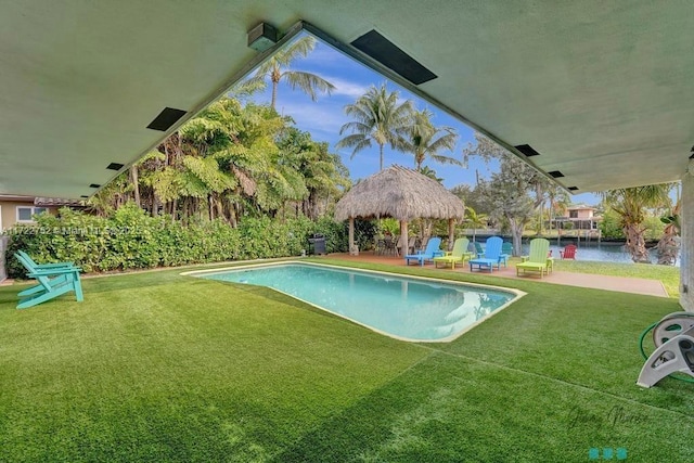 view of swimming pool featuring a gazebo, a yard, and a water view