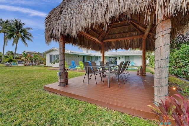 wooden terrace with a gazebo and a yard