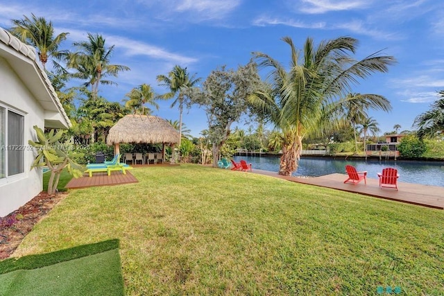 view of yard with a gazebo and a deck with water view