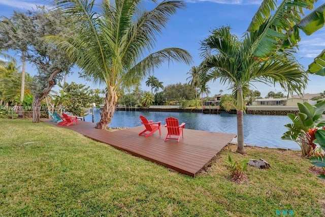 dock area featuring a lawn and a water view