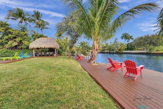 view of dock with a lawn, a water view, and exterior bar