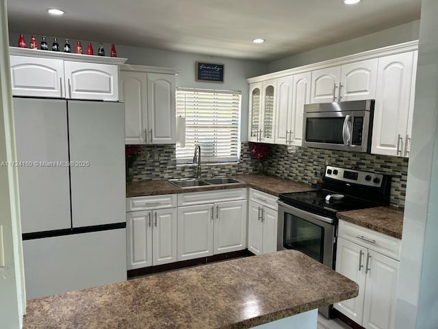 kitchen featuring tasteful backsplash, stainless steel appliances, sink, and white cabinets