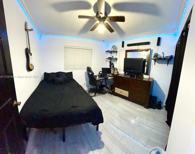 bedroom featuring crown molding, ceiling fan, and light hardwood / wood-style flooring