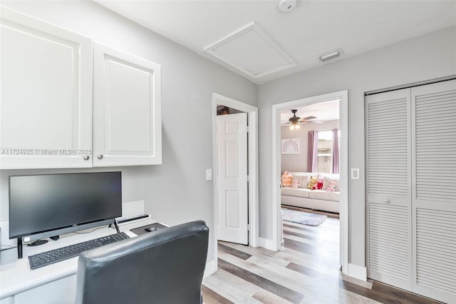 home office with light hardwood / wood-style floors