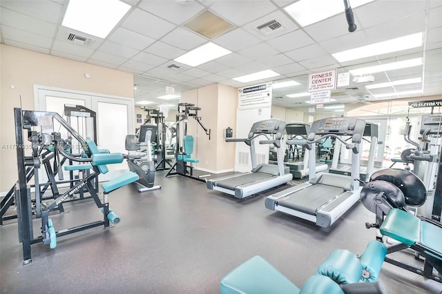 exercise room with a drop ceiling