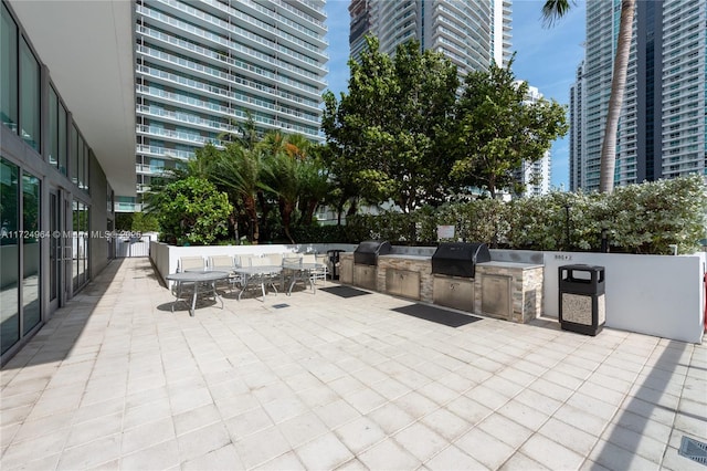 view of patio with an outdoor kitchen and area for grilling