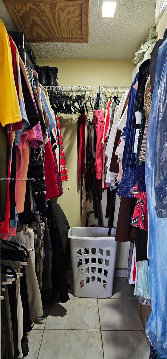 spacious closet featuring tile patterned flooring