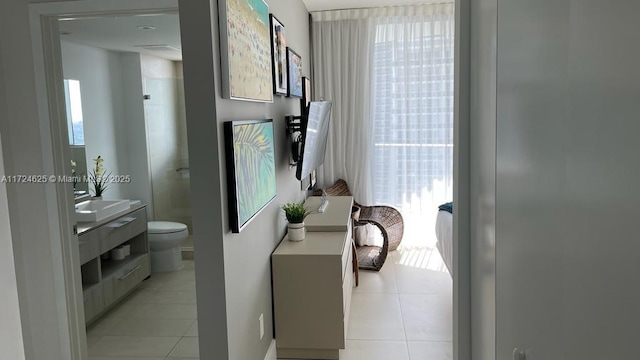 bathroom featuring tile patterned flooring, vanity, plenty of natural light, and toilet