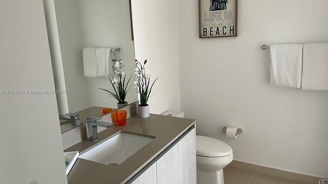 bathroom featuring tile patterned flooring, vanity, and toilet