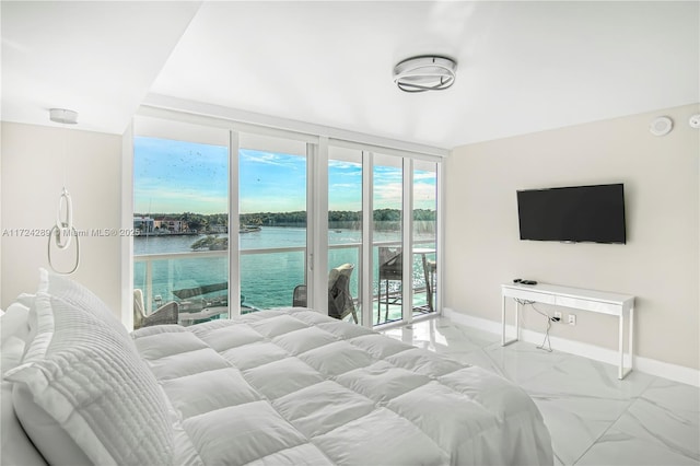 bedroom with floor to ceiling windows and access to exterior