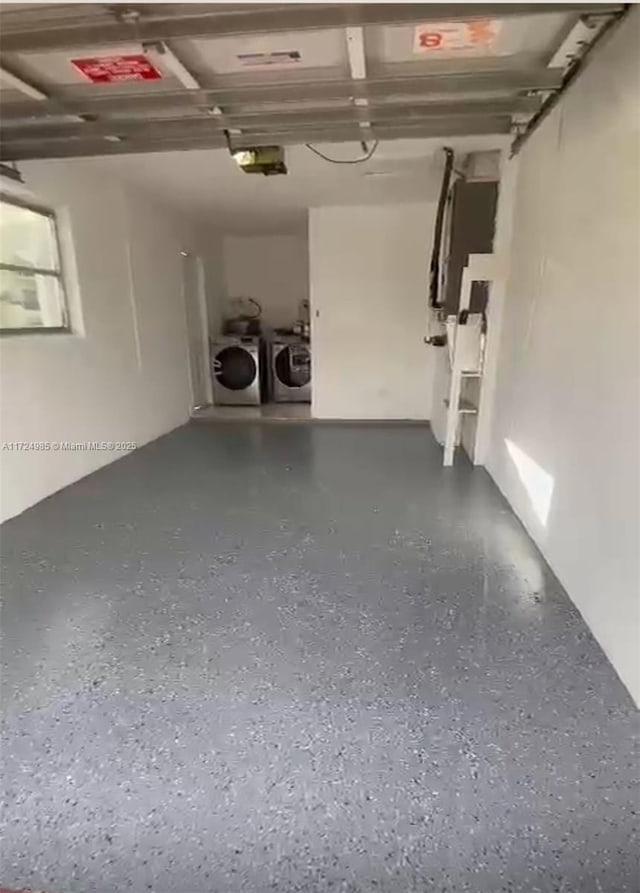 garage featuring washer and clothes dryer and a garage door opener