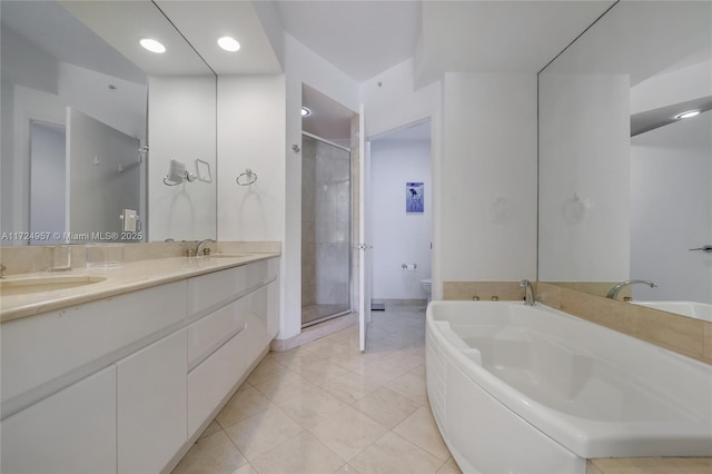 full bathroom with shower with separate bathtub, tile patterned flooring, vanity, and toilet