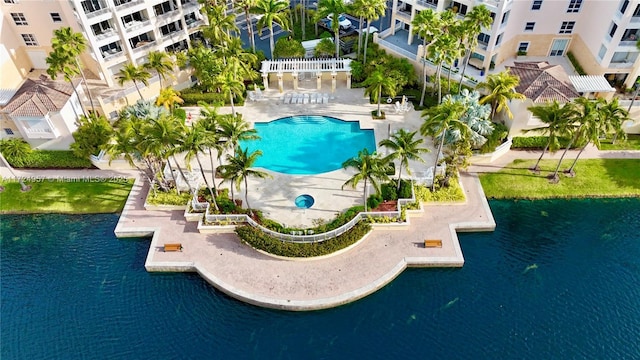 view of pool featuring a patio and a water view