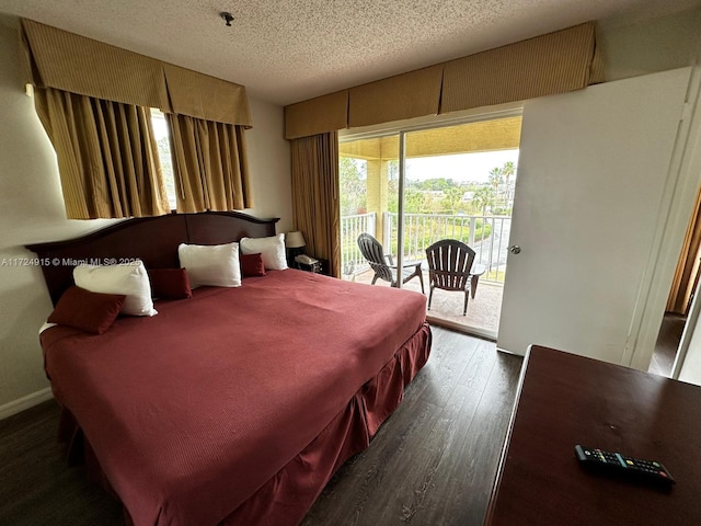 bedroom featuring dark hardwood / wood-style flooring, a textured ceiling, and access to outside