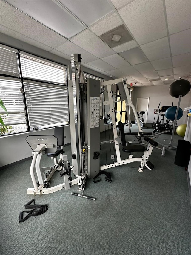 gym with a paneled ceiling