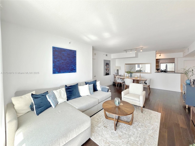 living room with hardwood / wood-style flooring and track lighting