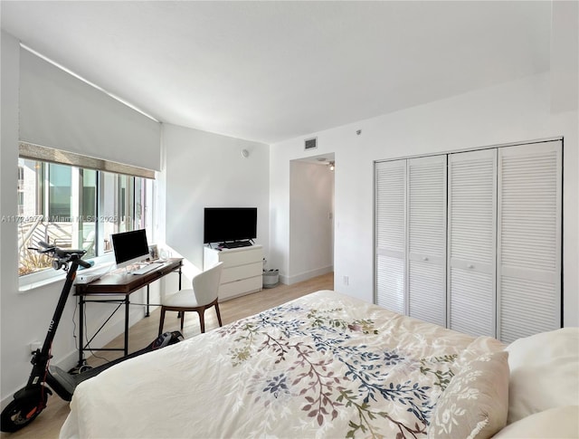 bedroom with a closet and light hardwood / wood-style flooring