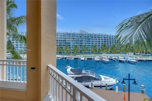 balcony featuring a dock and a water view