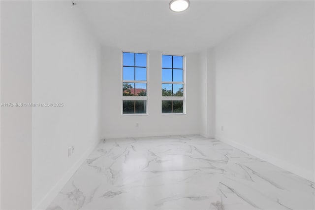 empty room with marble finish floor and baseboards