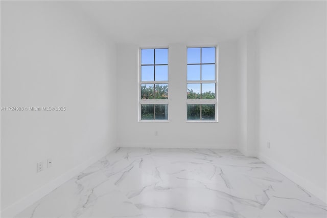 unfurnished room featuring marble finish floor