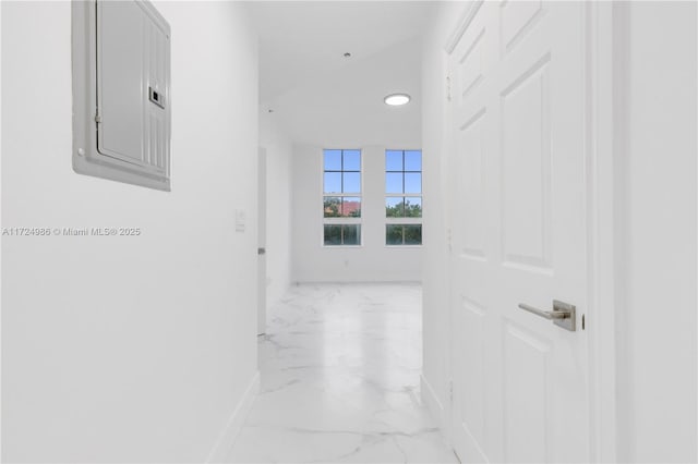 corridor with marble finish floor, electric panel, and baseboards