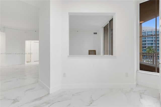 interior space featuring marble finish floor and baseboards