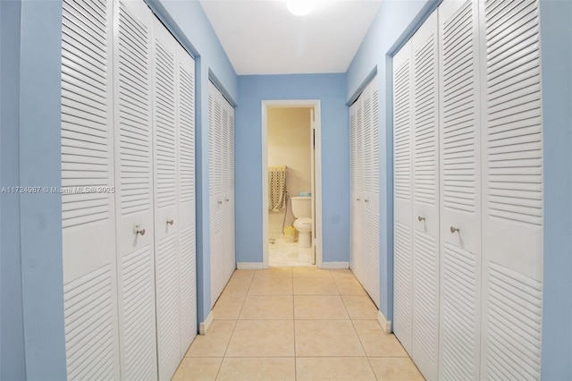 hall with light tile patterned floors