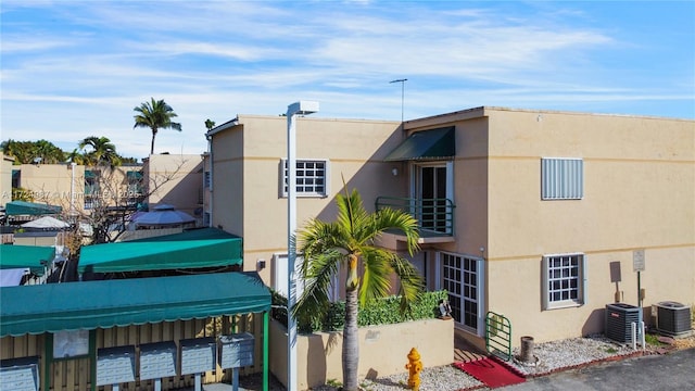 view of building exterior with central AC unit