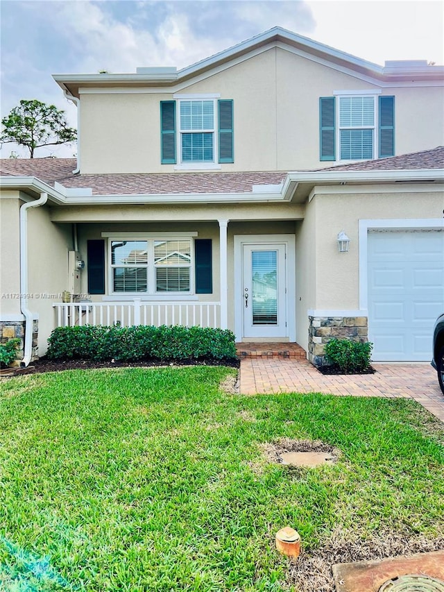 front facade with a front yard and a garage