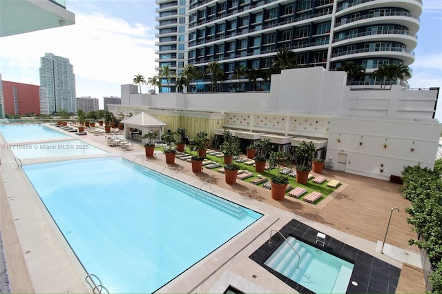 view of swimming pool with a gazebo, a patio, and a hot tub