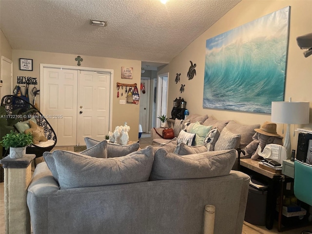 living room featuring light tile patterned floors and a textured ceiling