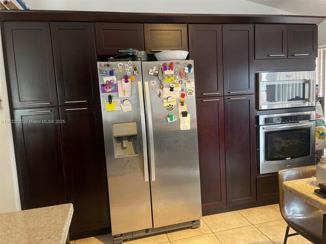 kitchen featuring stainless steel appliances and light tile patterned floors