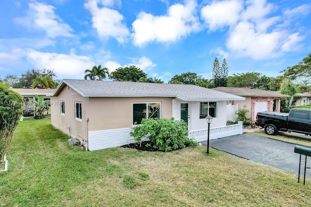 ranch-style home with a front lawn and a garage