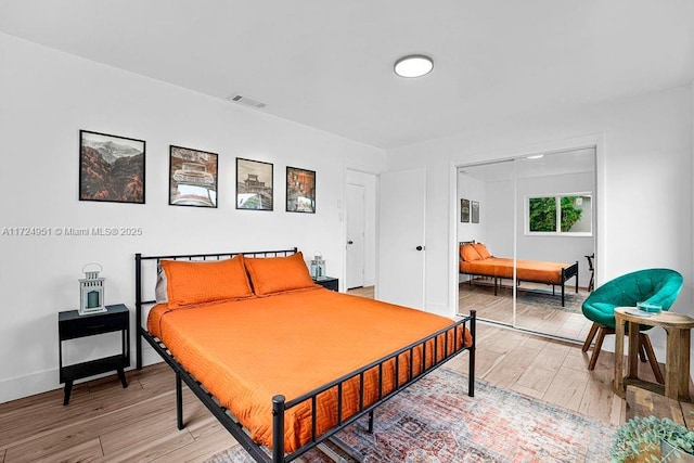 bedroom with hardwood / wood-style flooring and a closet